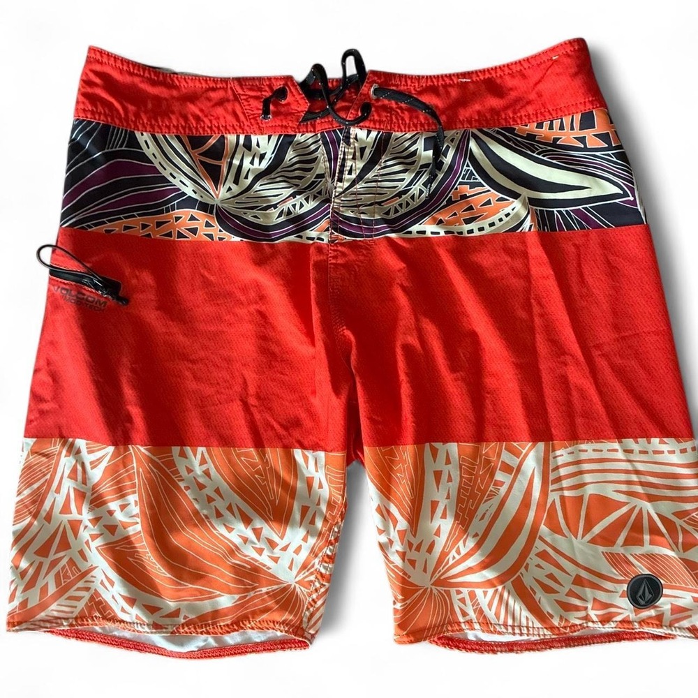 Preowned 2015 Volcom board shorts with orange, white, and black abstract